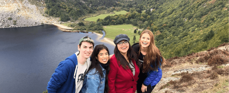 Students on a mountain overlooking a lake